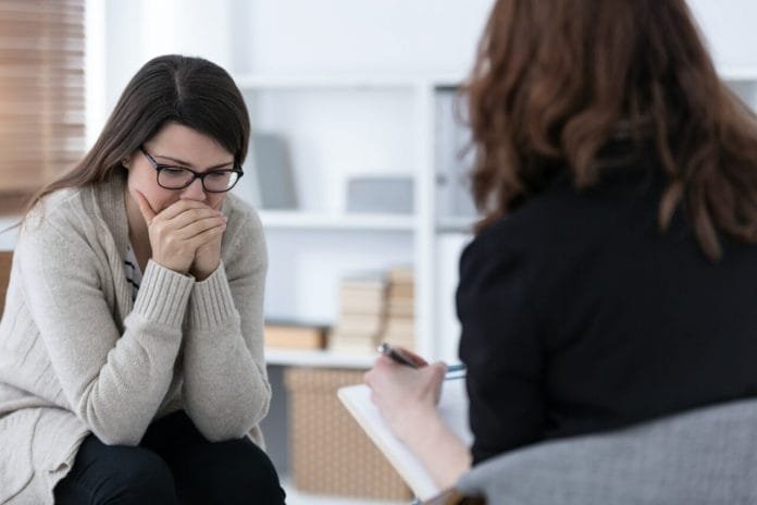 sad-woman-crying-during-psychotherapy-at-professional-clinic