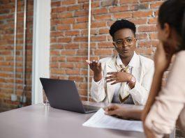 Black businesswoman talking to a candidate during job interview in the office.